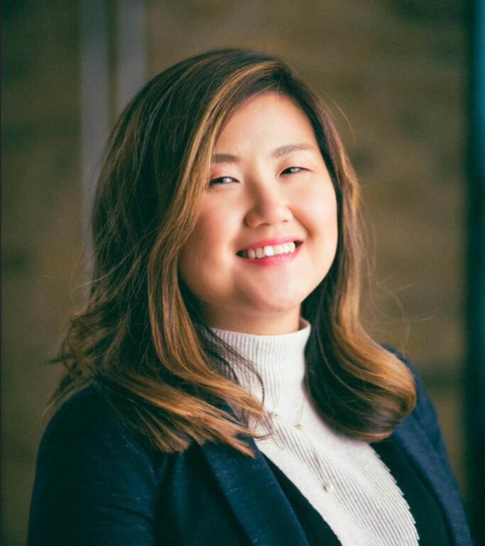 Qin Su, author and financial coach, smiling in professional headshot